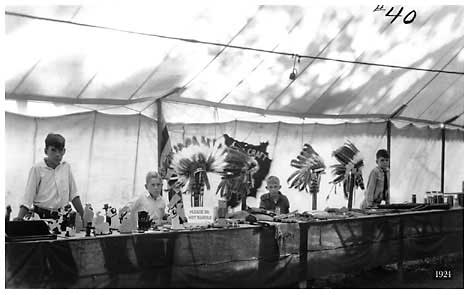 four boys display collections, woodworking and Native American head dress