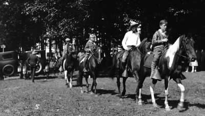 horseback riders parade onto the fairgrounds